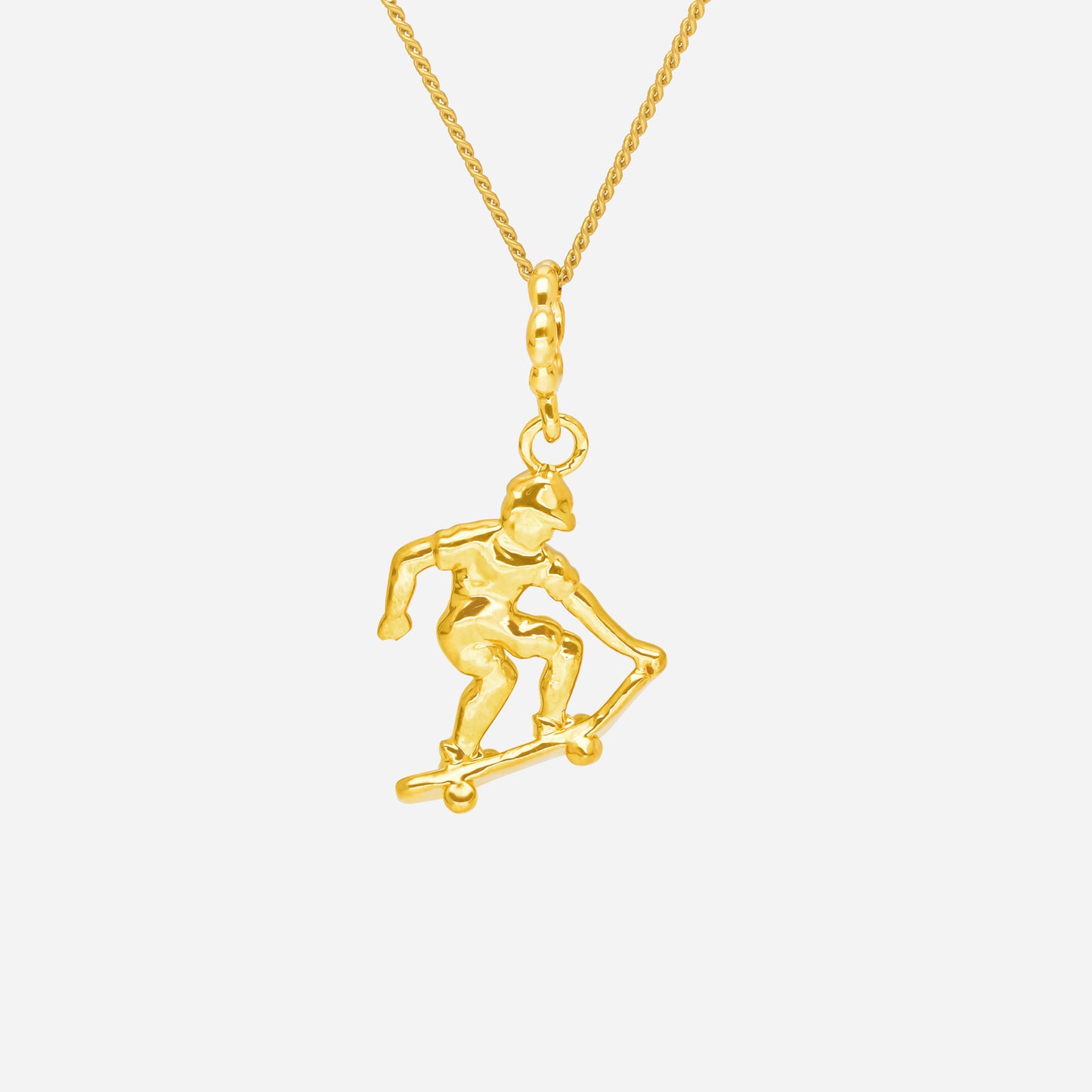 ace of skateboarding pendant in 22k yellow gold featuring a detailed skateboarder silhouette.