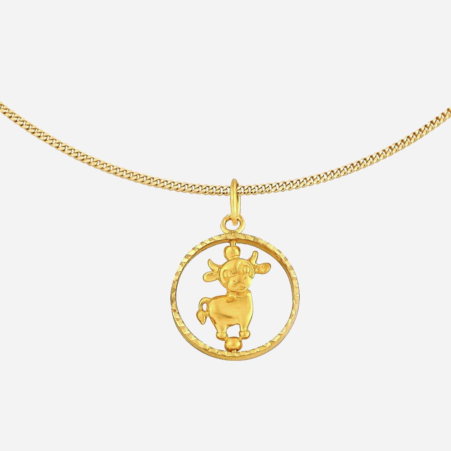 ox pendant in 22k yellow gold featuring a detailed cow design within a circular frame. chain sold separately.