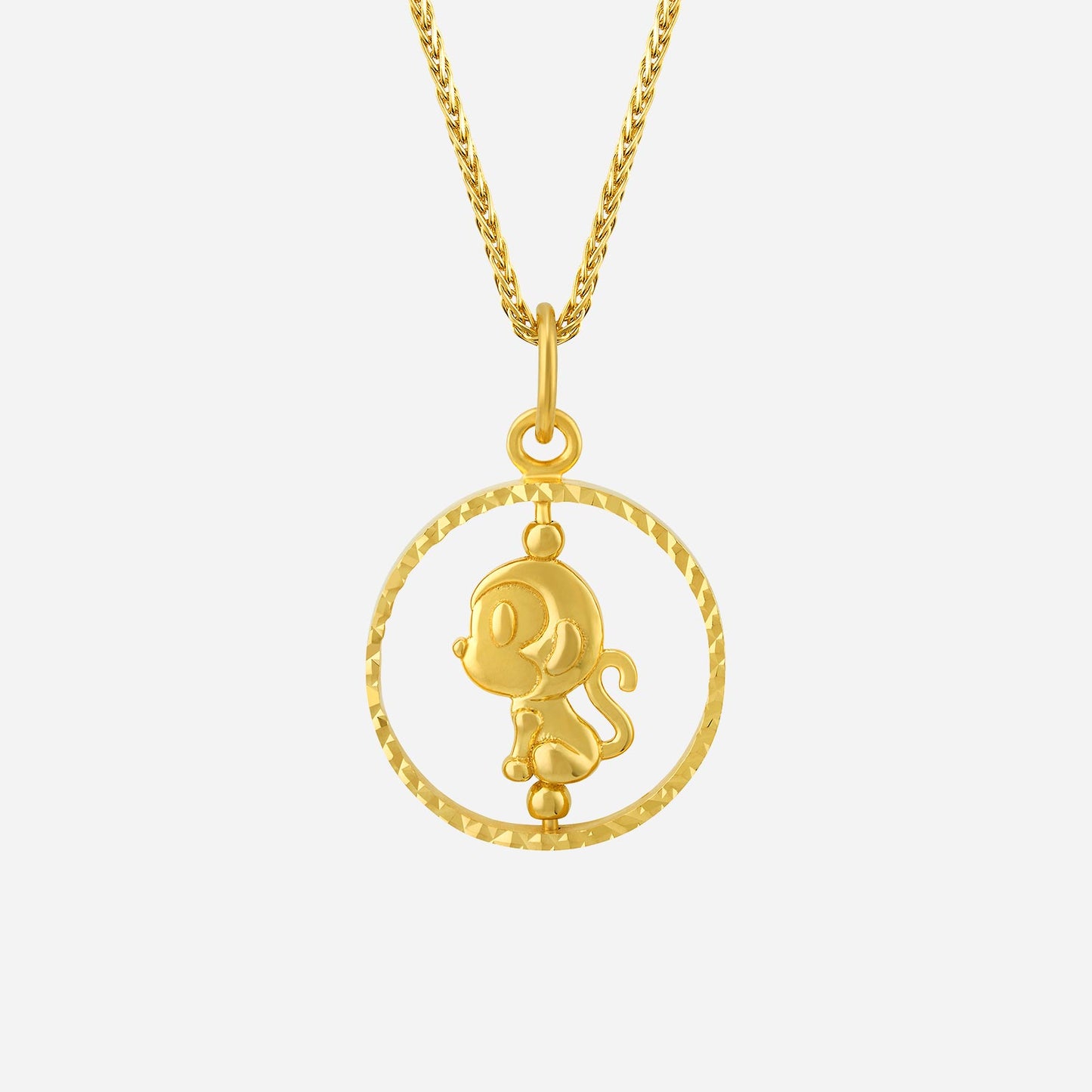 monkey pendant in 22k yellow gold with a playful monkey design inside a textured circular frame.