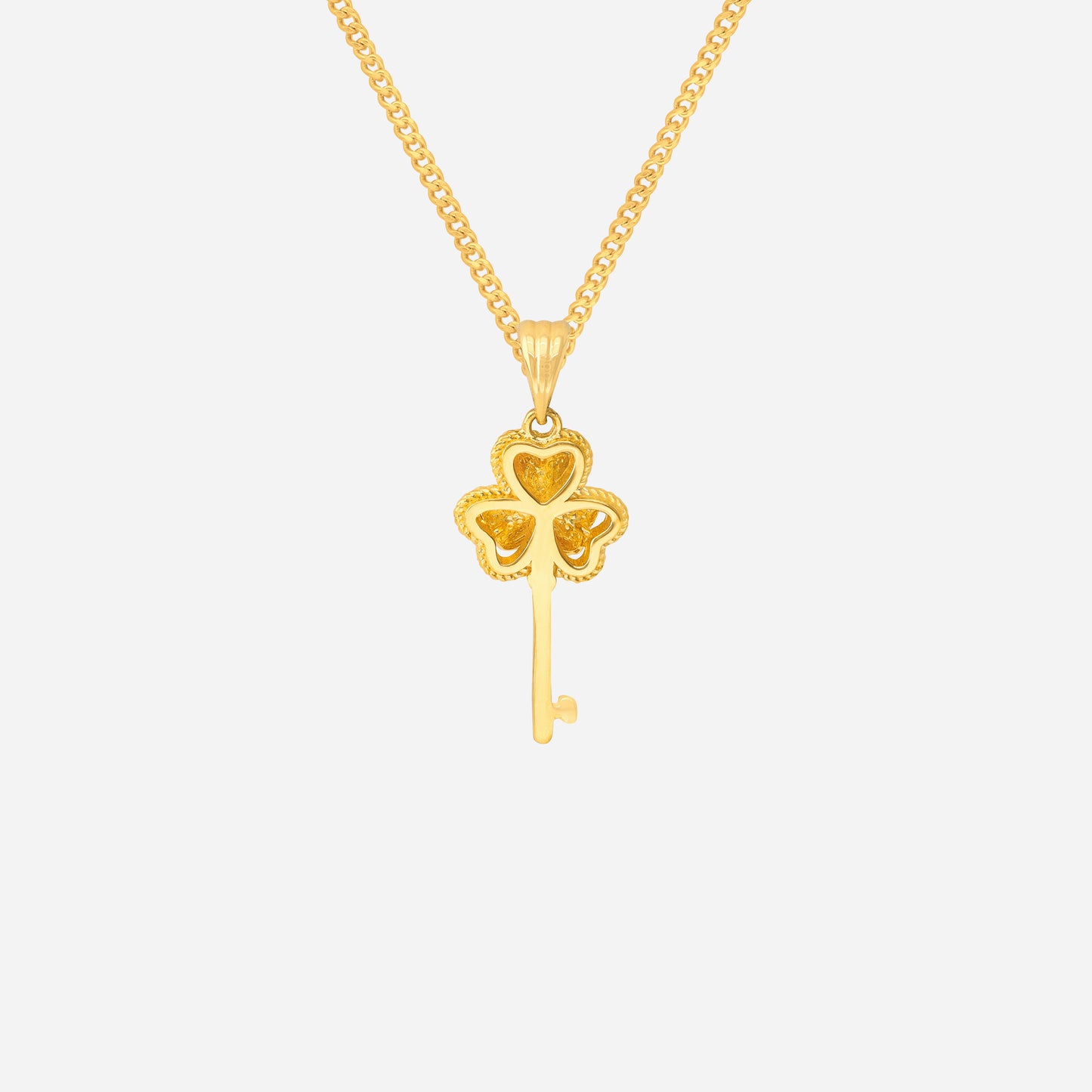 clover key pendant in 24k yellow gold featuring a four-leaf clover design with a slender key.