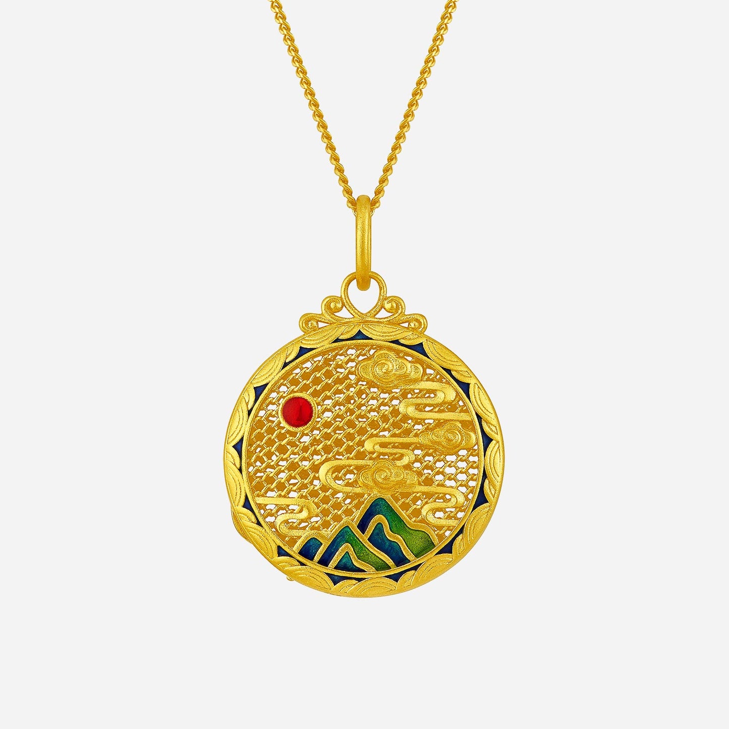 deer pendant in 24k yellow gold with vibrant enamel accents, depicting clouds and mountains with a red gemstone.
