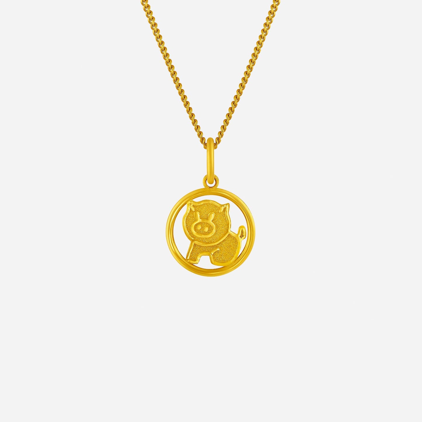 harmonies of joy pig pendant in 24k yellow gold with a charming pig design in a circular frame. chain sold separately.