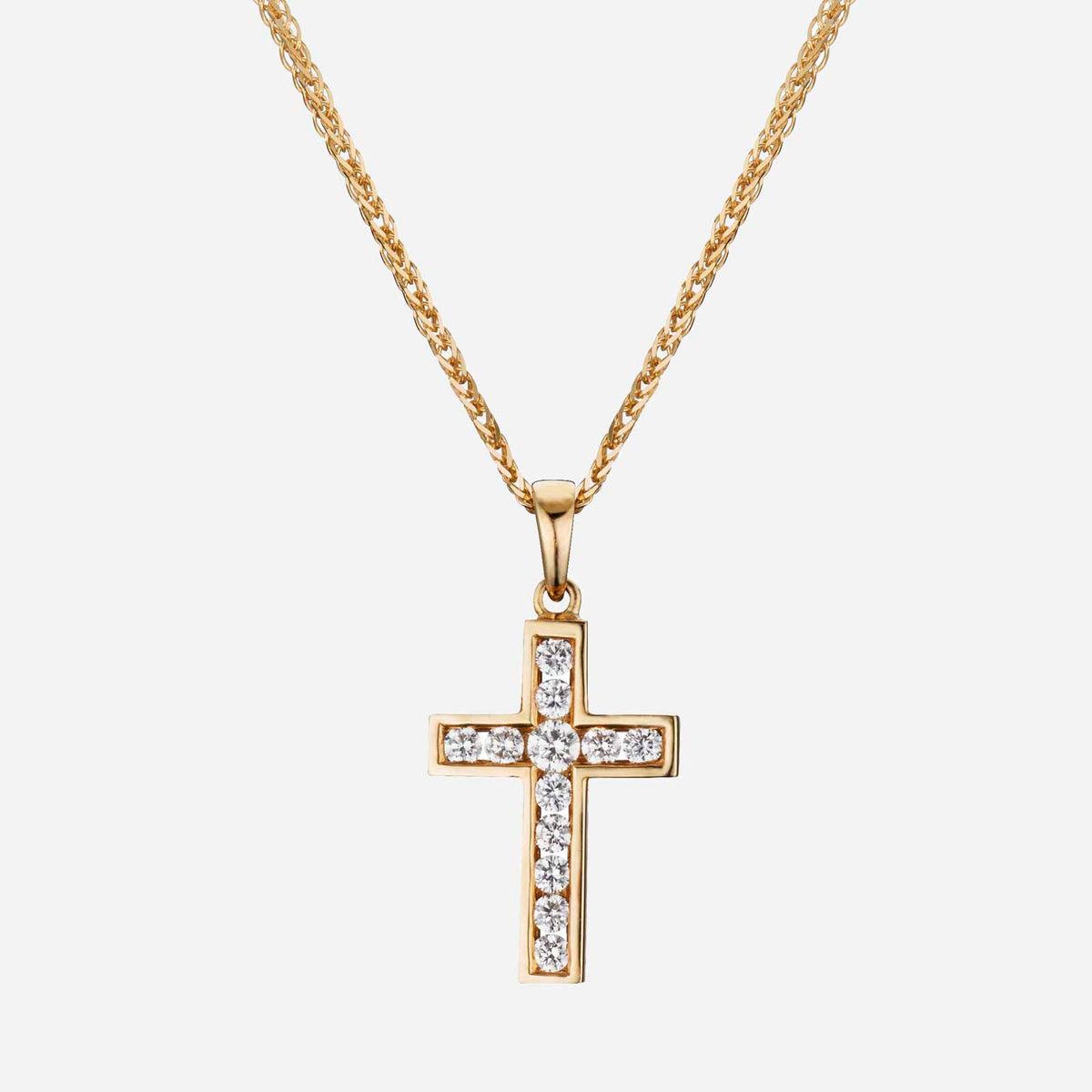 yellow gold cross pendant adorned with round brilliant diamonds, featuring a classic, elegant design.