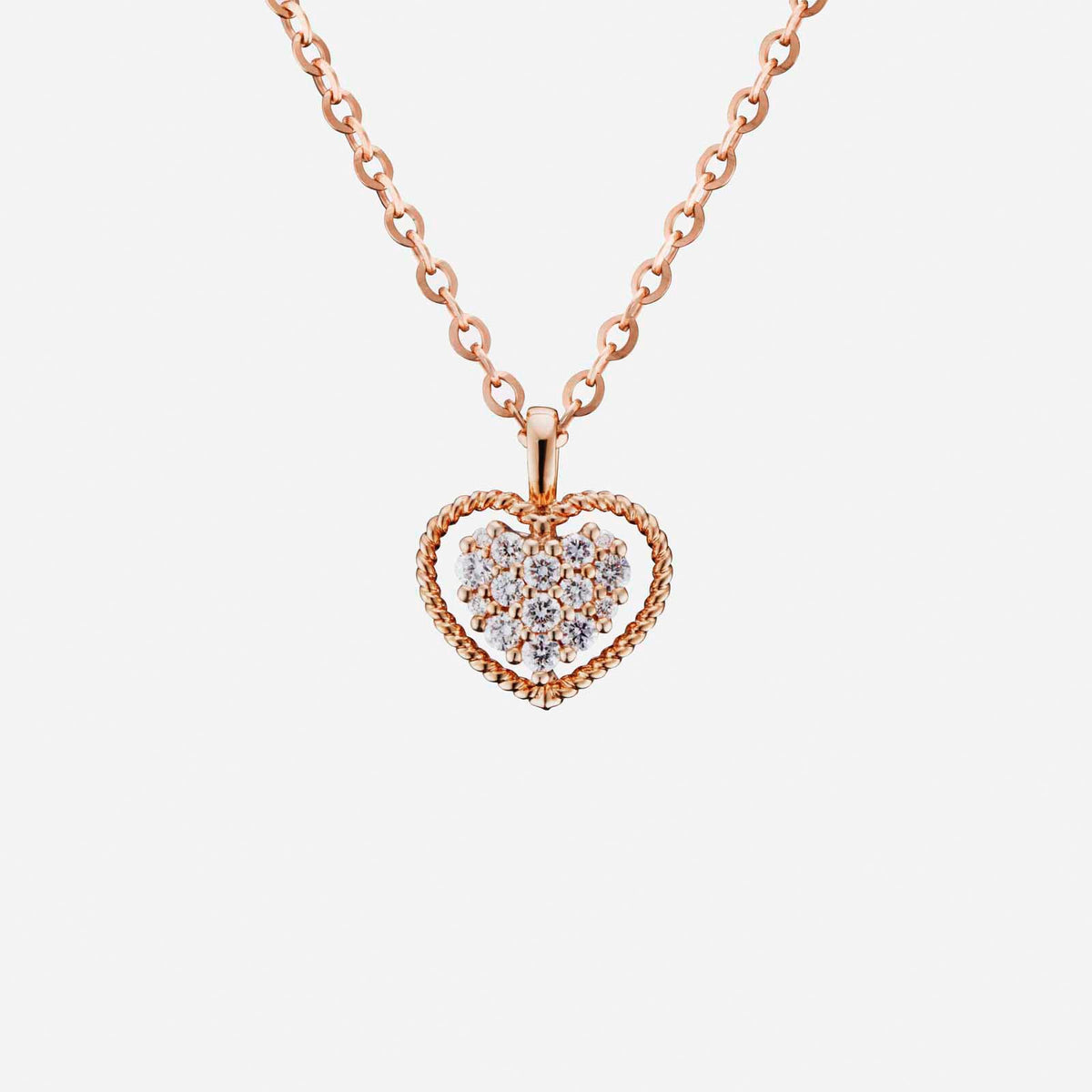 heart-shaped diamond pendant in rose gold with intricate twisted design, featuring multiple sparkling diamonds.