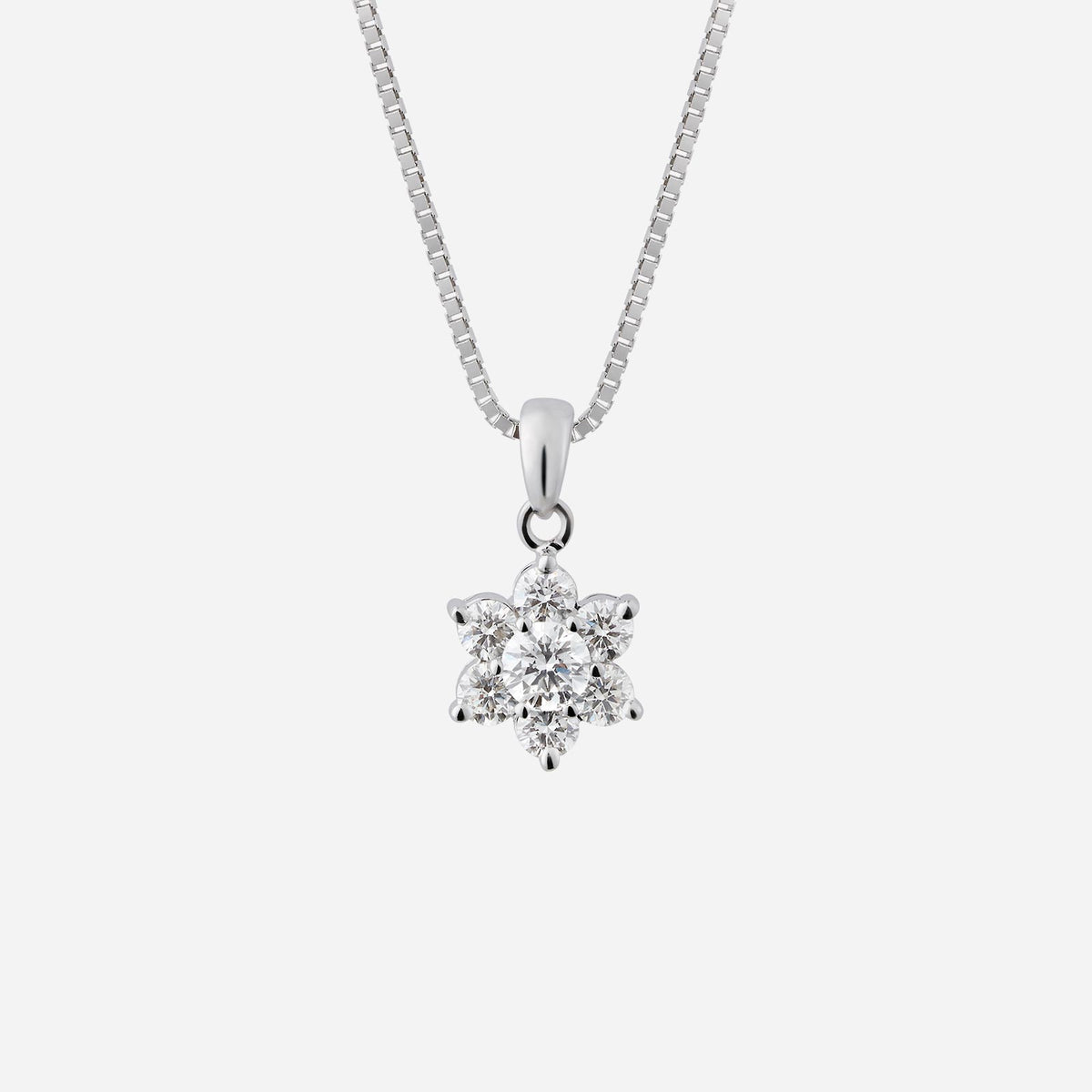 blossom diamond pendant in 18k white gold featuring a flower design with 7 sparkling diamonds. chain not included.