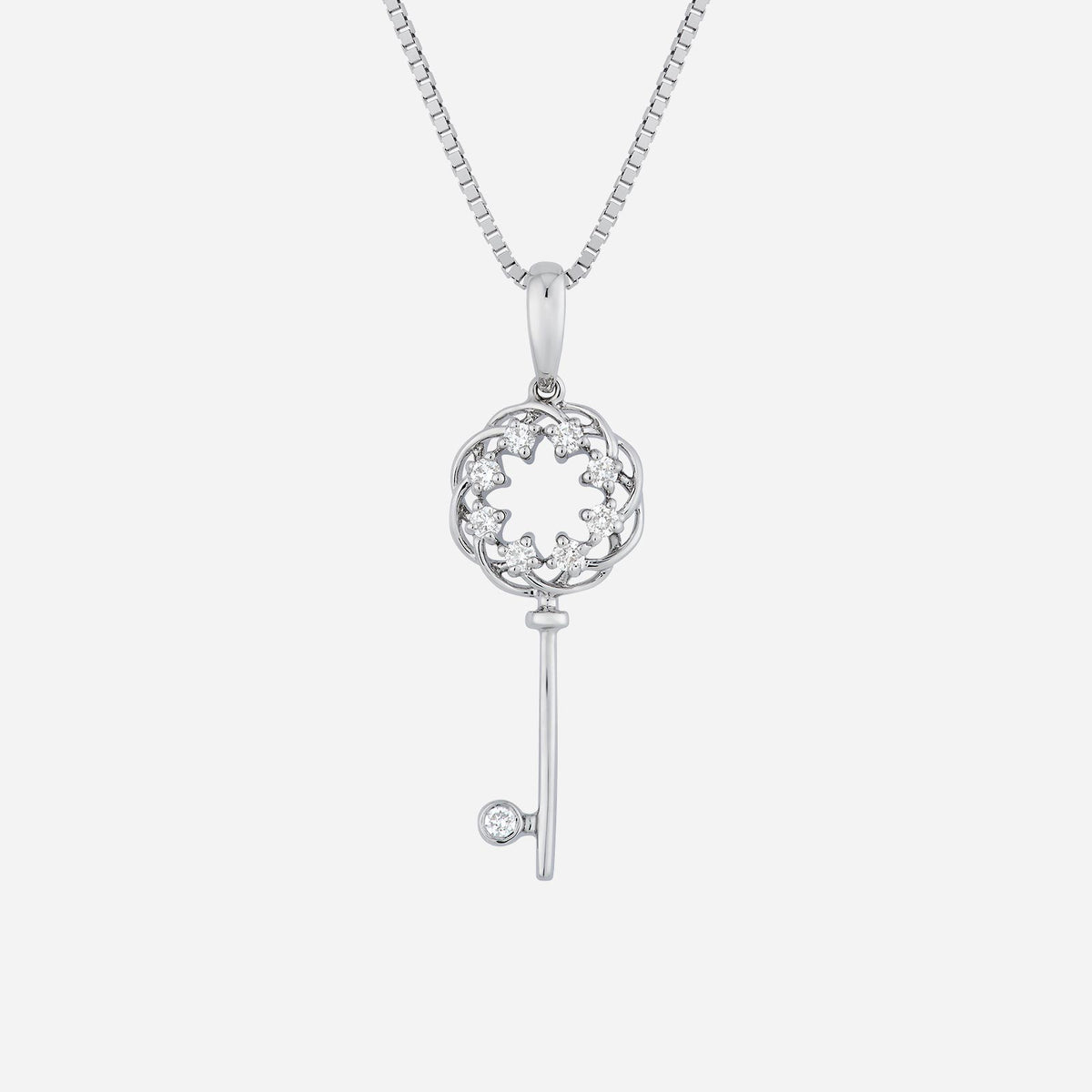 diamond key pendant in 18k white gold with intricate floral design and sparkling diamonds. chain sold separately.