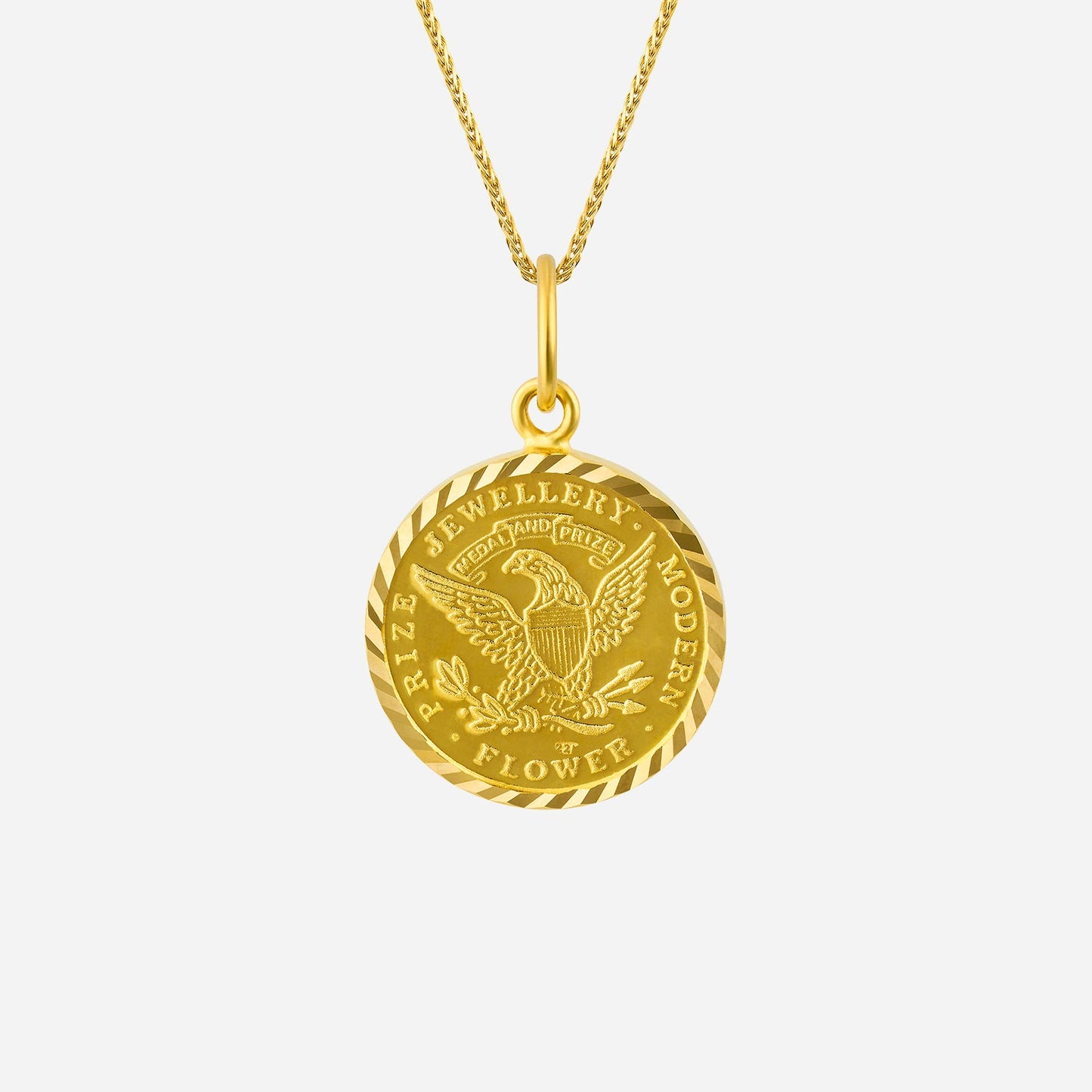 intricate 22k yellow gold medallion pendant with an eagle design and twisted border detail.