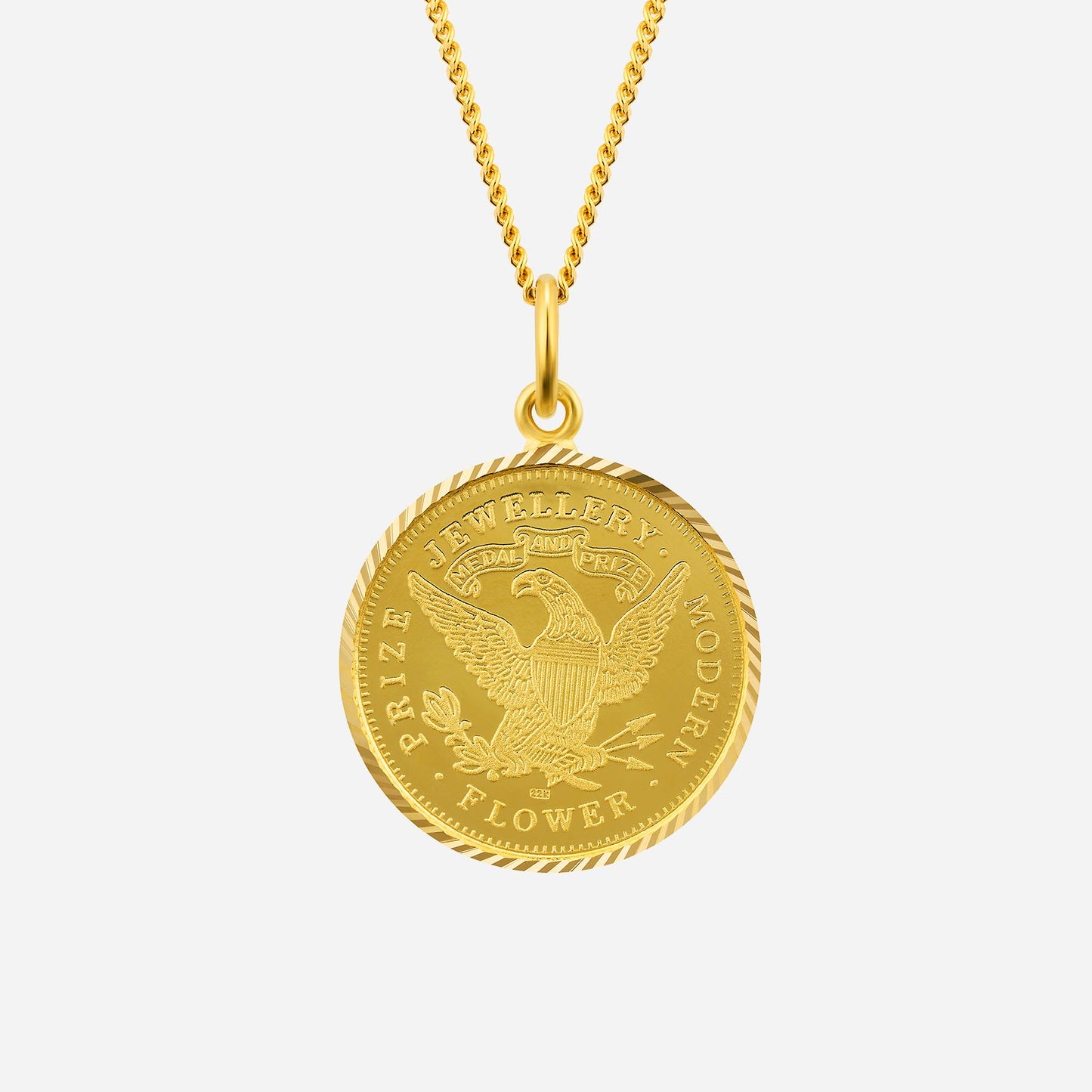 intricate 22k yellow gold pendant featuring a medallion design with an eagle motif. chain not included.