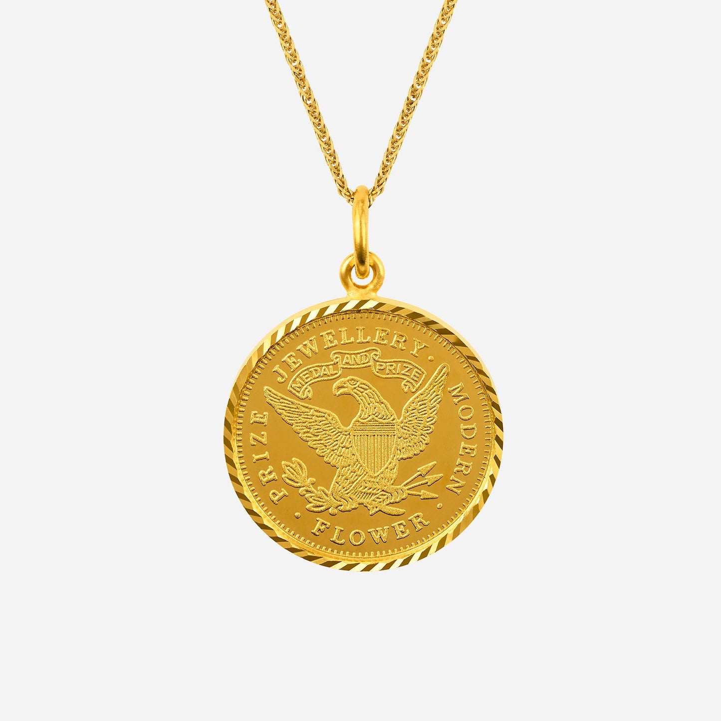 intricate 24k yellow gold pendant featuring an eagle design, perfect for elegant accessorizing. chain sold separately.