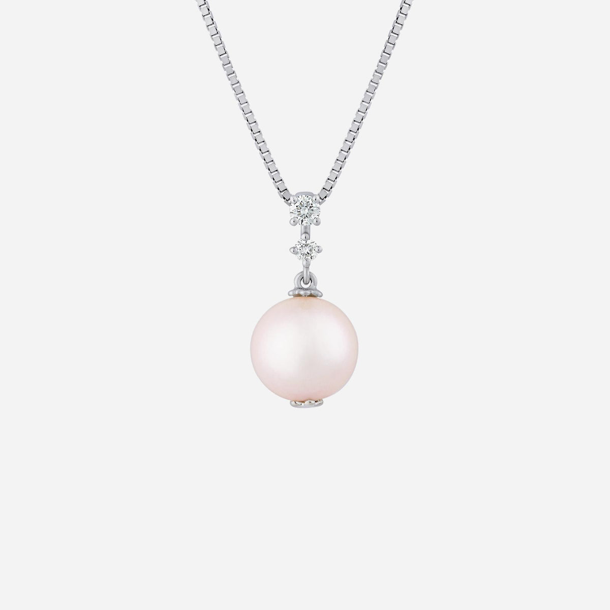 pearl pendant in 18k white gold featuring a large pink pearl and three sparkling diamonds above.