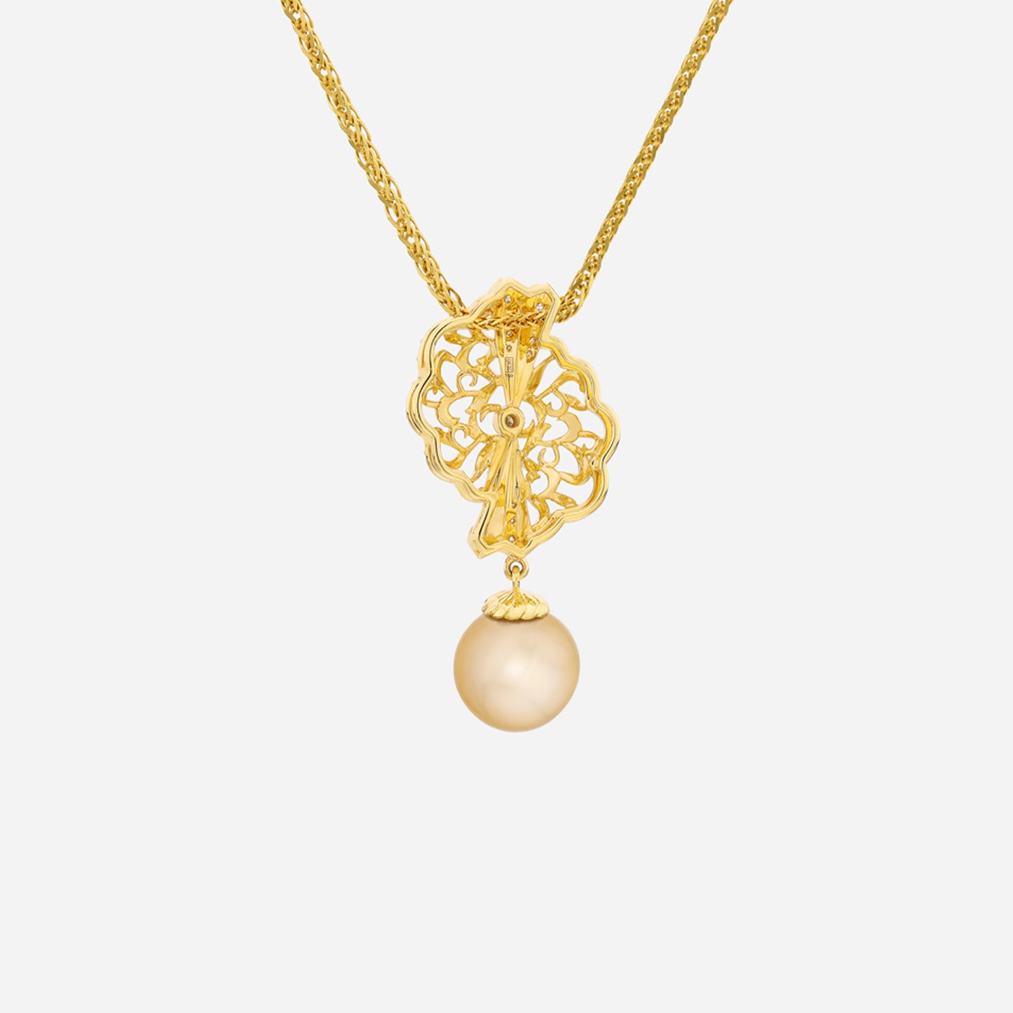 legacy south sea pearl pendant in 18k yellow gold featuring intricate lace design and a lustrous golden pearl.