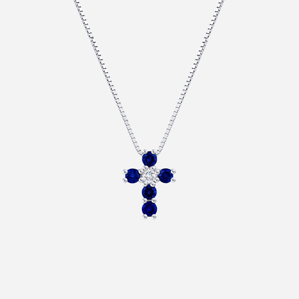 blue sapphire cross pendant with diamond accents, set in 18k white gold for a timeless and elegant design.