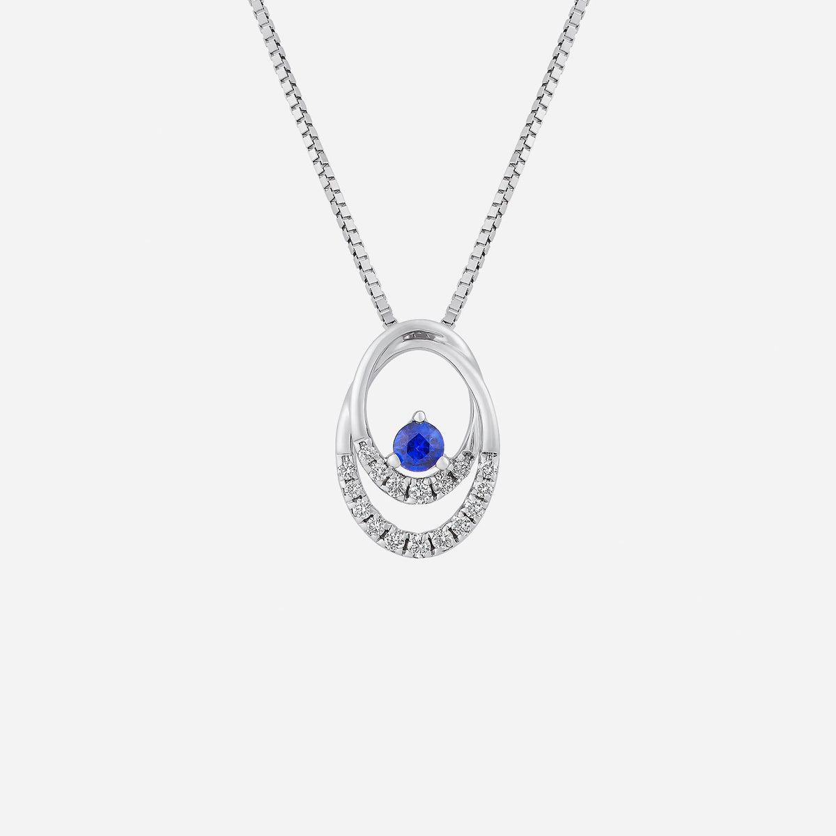 ovate blue sapphire pendant with diamond accents in polished 18k white gold, featuring a modern double-loop design.