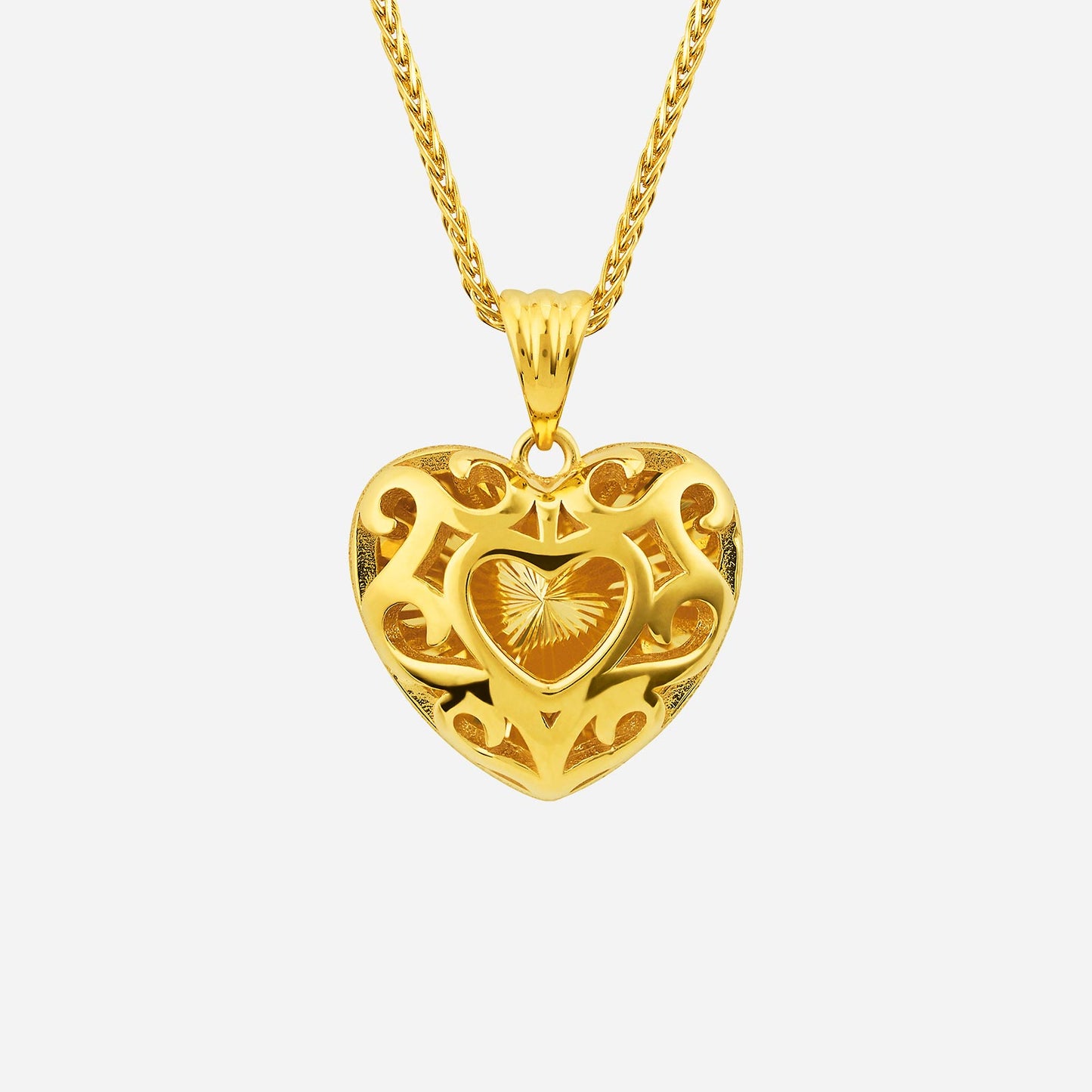 22k yellow gold heart pendant with intricate design and smaller heart detail, perfect for expressing love and affection.