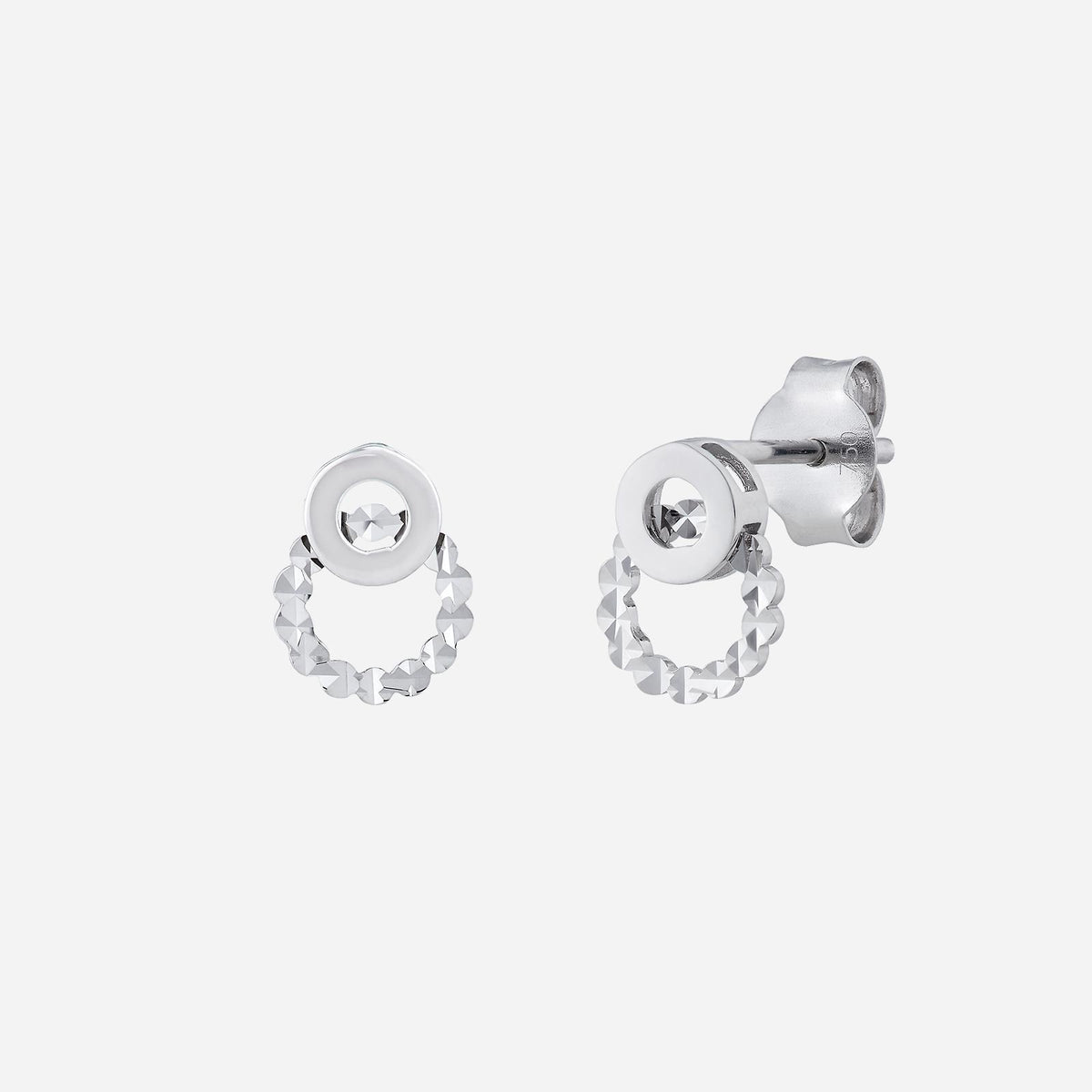 18k white gold earrings featuring smooth and textured round designs with a sparkling centerpiece.