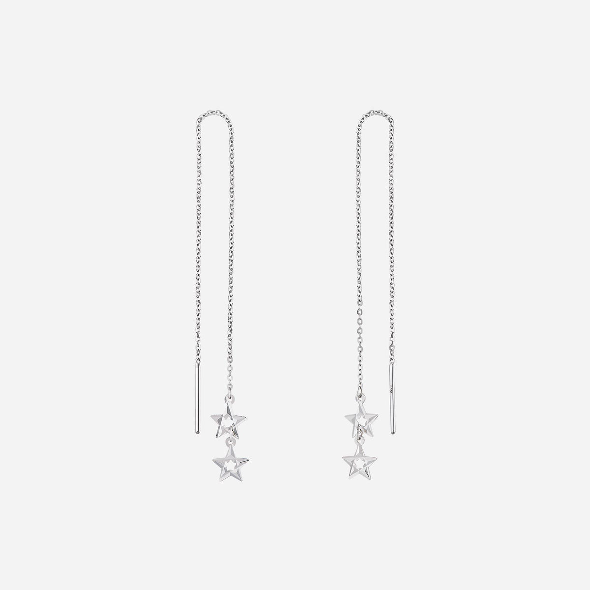 star earrings in 18k white gold with dangling chains and delicate star charms for a whimsical look.