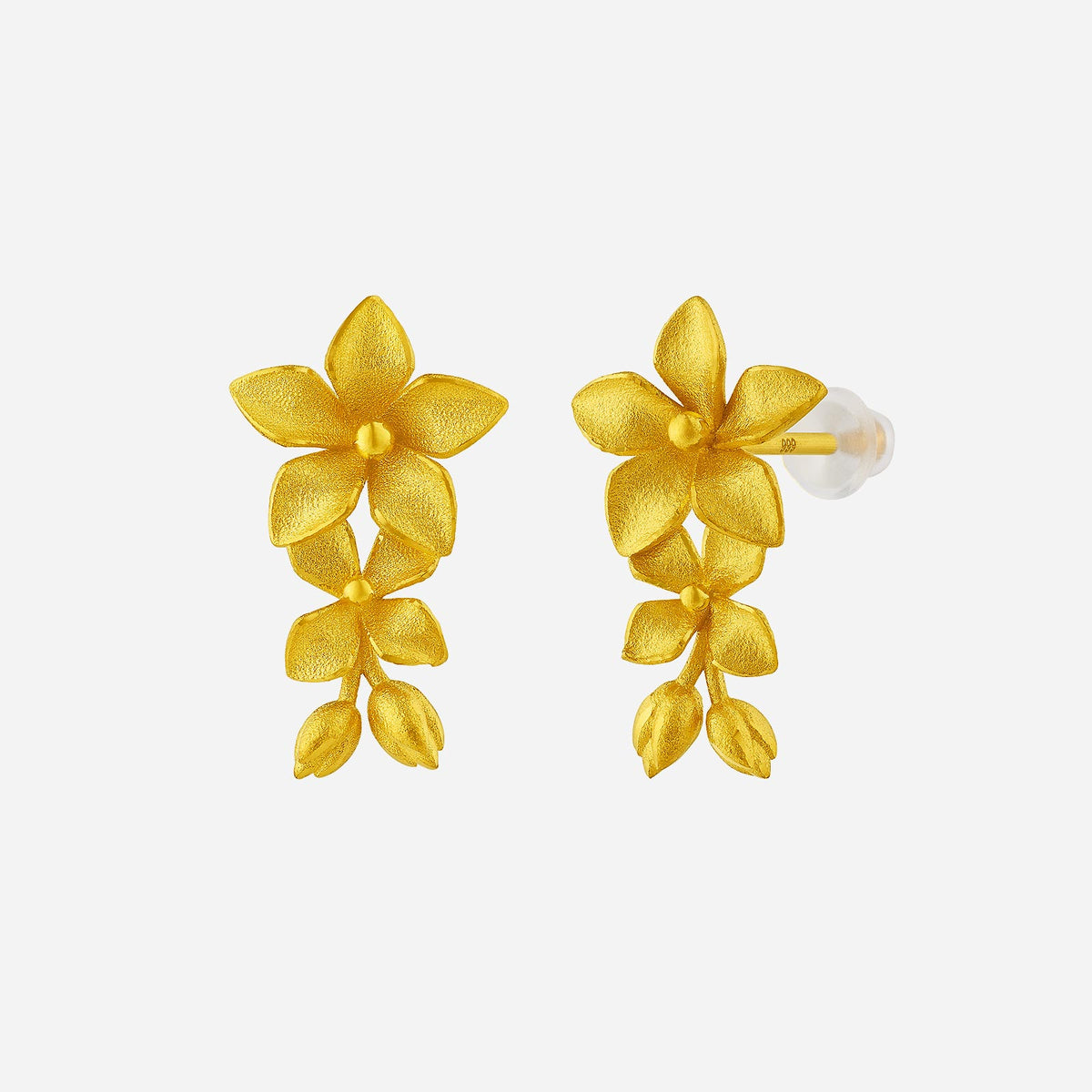 myosotis earrings in 24k yellow gold featuring flower and leaf design with silicone stud-stoppers.