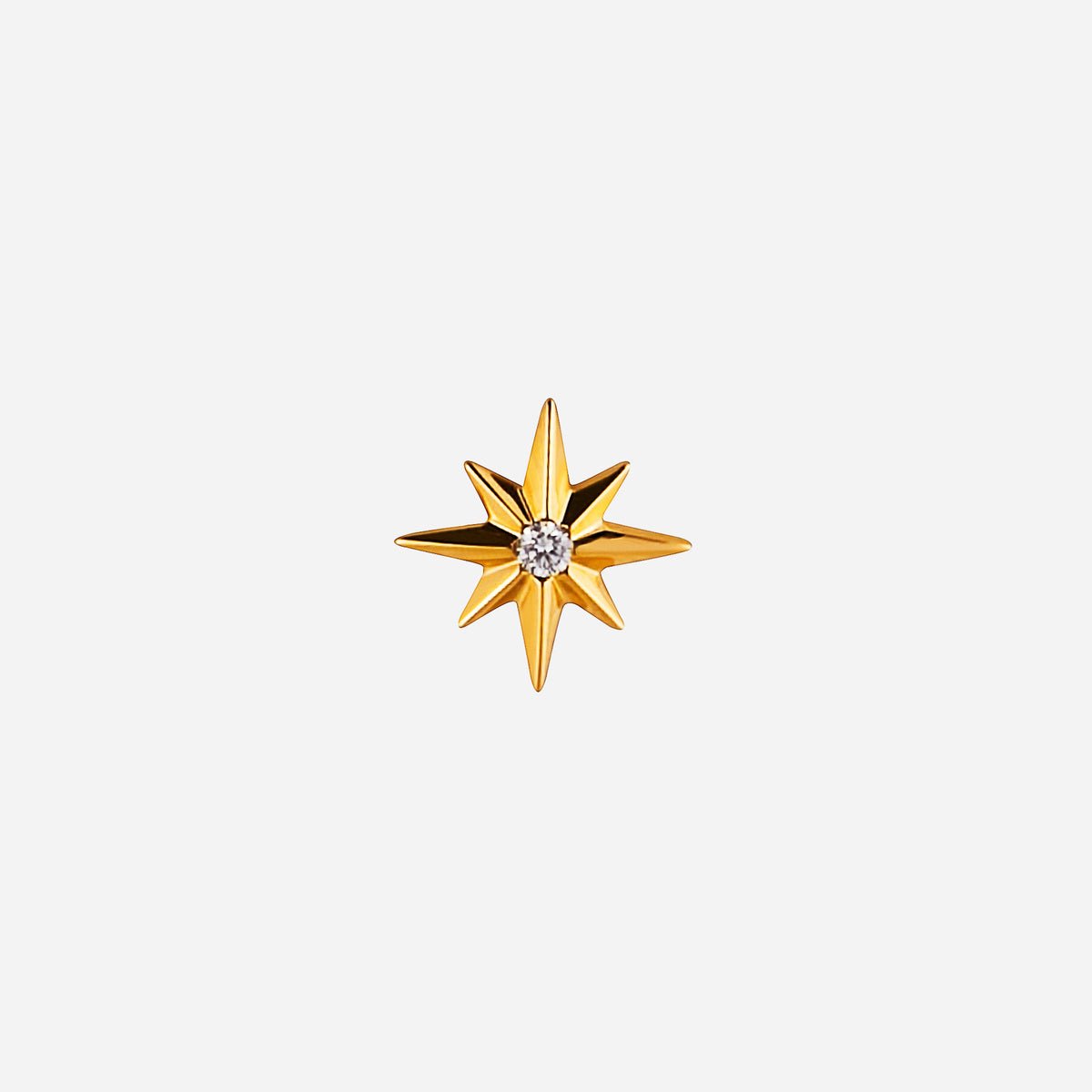 18k yellow gold star-shaped stud earring with a central diamond, perfect for a stylish and bold accessory.