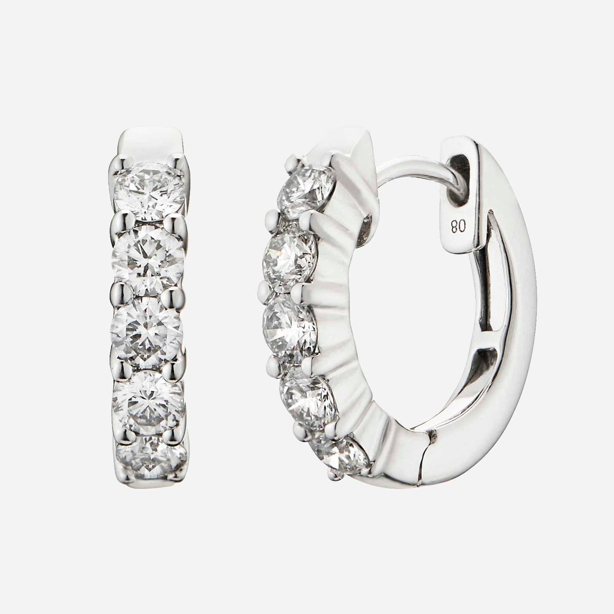 huggie earrings in 18k white gold set with round brilliant diamonds, totaling 0.60 carats in a sleek design.