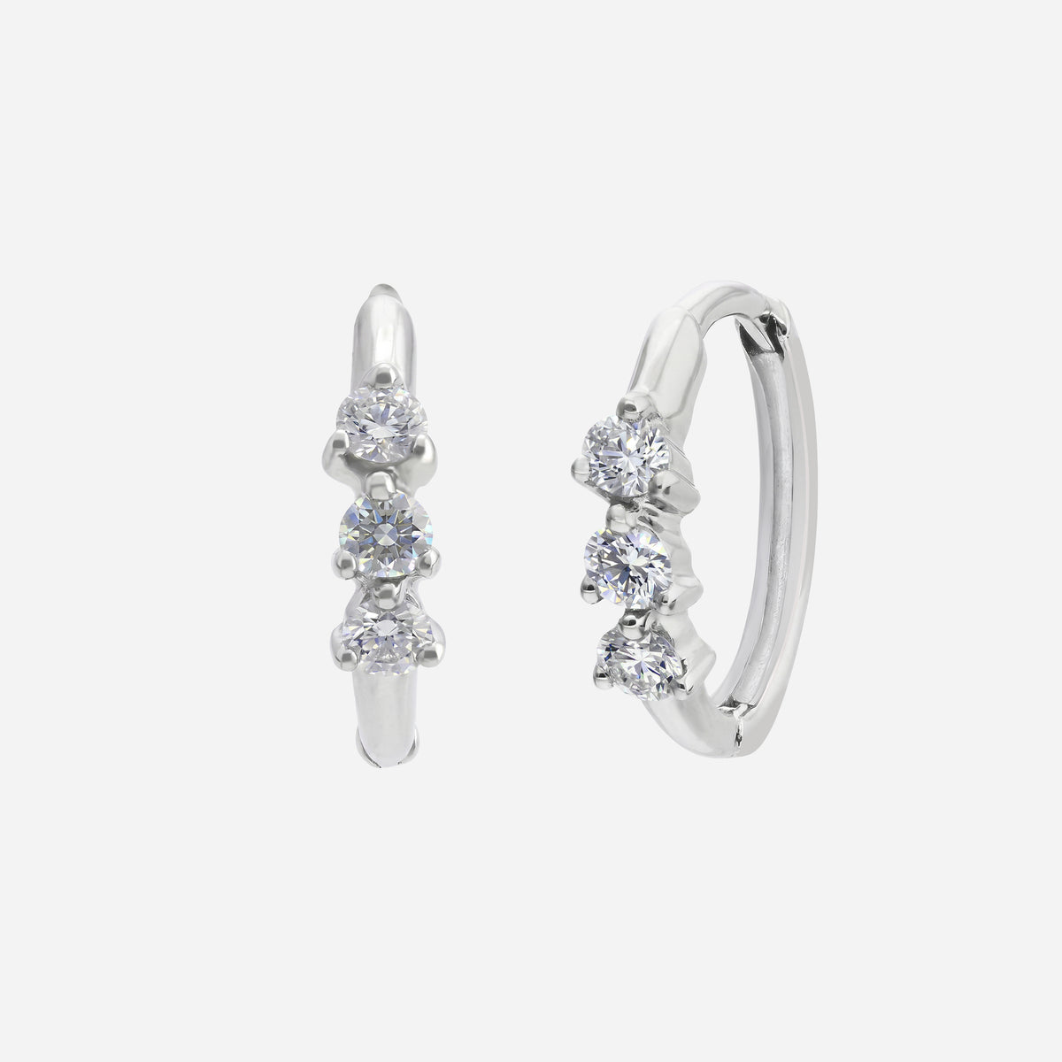trio spark diamond huggie earrings in polished 18k white gold with three clustered diamonds. elegant and radiant design.