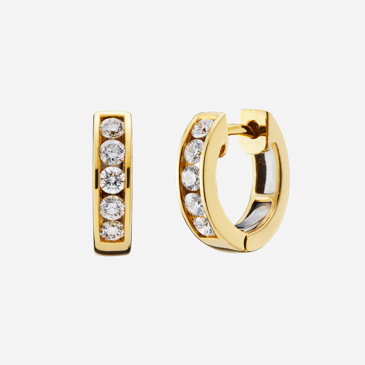 diamond huggie earrings in 18k yellow gold with sparkling diamonds in a modern hoop design.