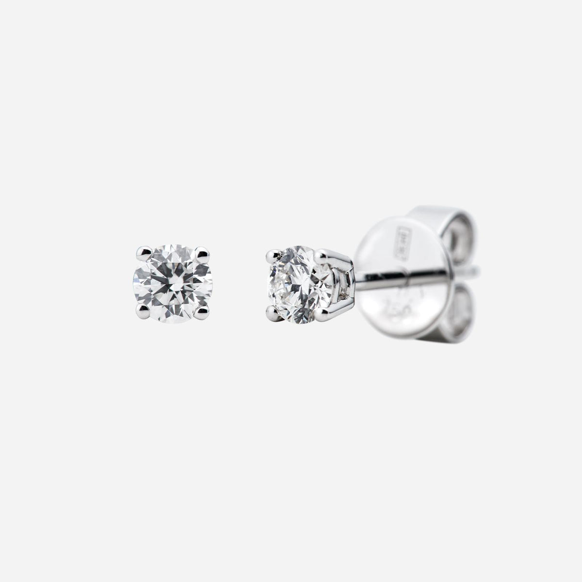 solitaire diamond stud earrings in 18k white gold featuring a brilliant round-cut design.