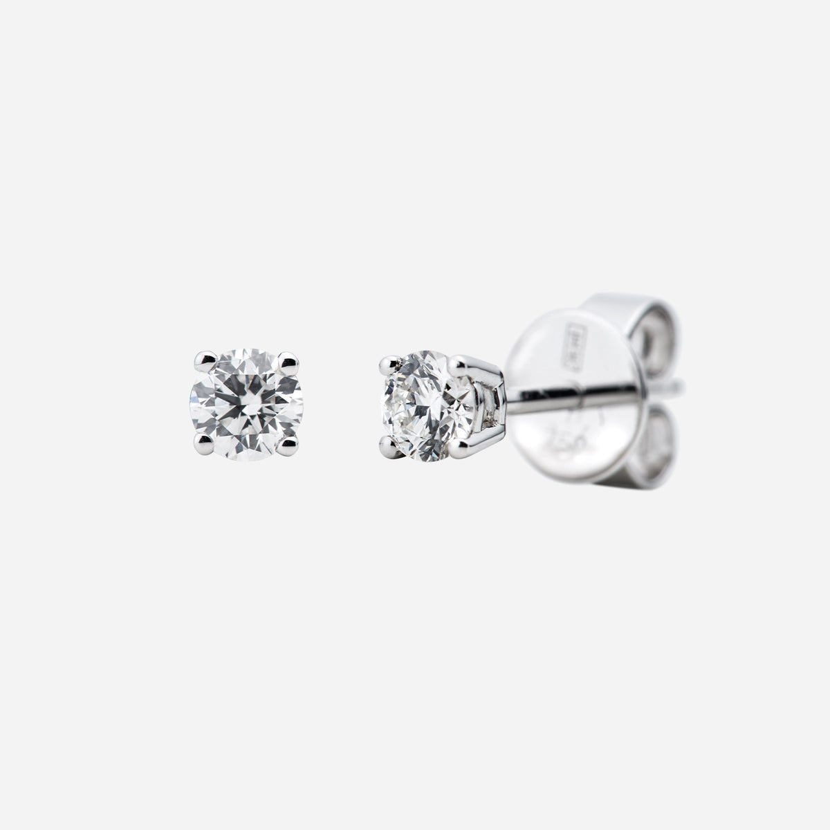 solitaire diamond stud earrings in 18k white gold with a classic four-prong setting and brilliant-cut diamonds.