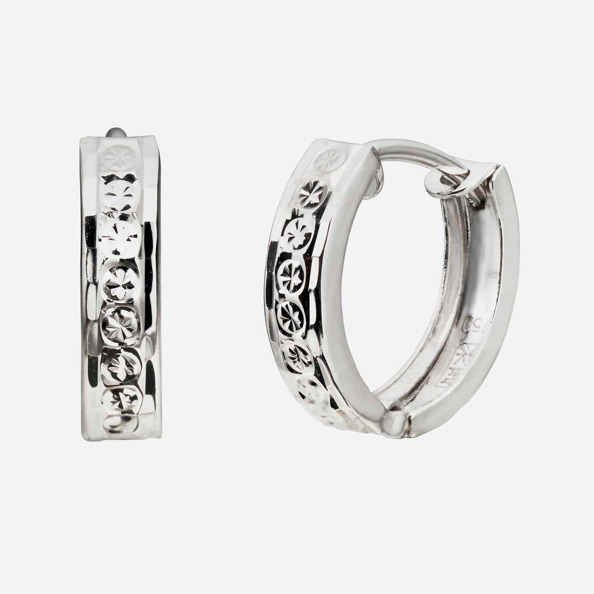huggie earrings in 18k white gold with intricate diamond engravings and a polished finish. perfect for gifting.
