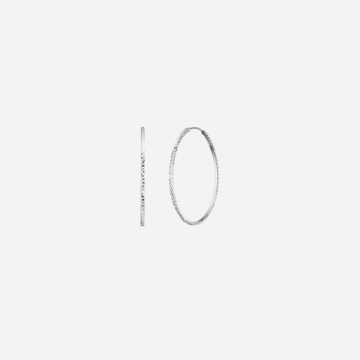 textured huggie earrings in 18k white gold featuring a classic hoop design with intricate cut detailing.