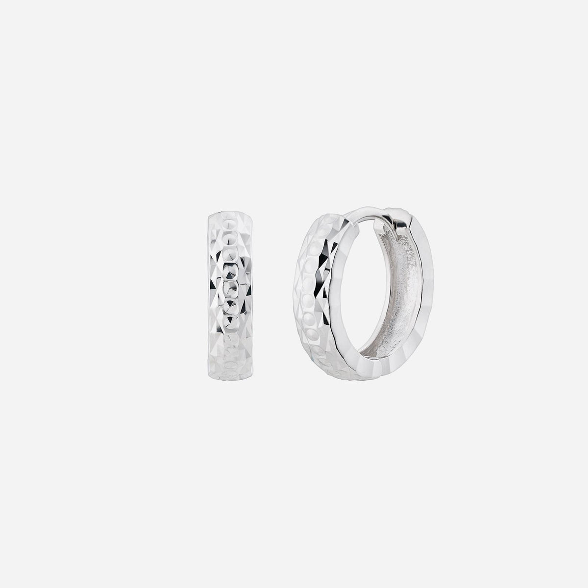 textured huggie earrings in shimmering 18k white gold with a striking geometric pattern. effortless elegance for any occasion.