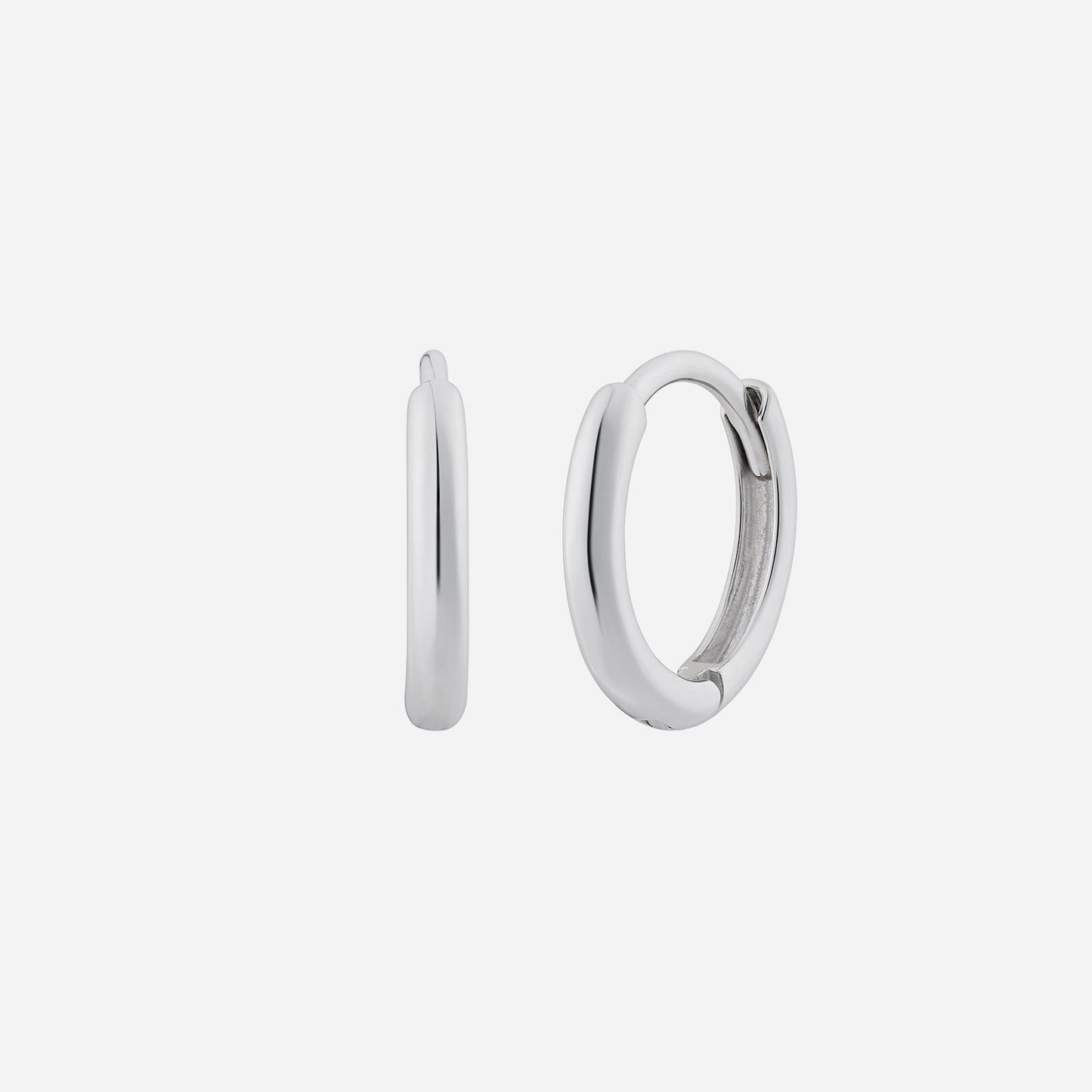 huggie earrings in polished 18k white gold, featuring a minimalist design with a smooth finish.