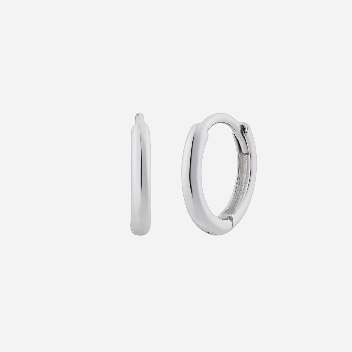 huggie earrings in 18k white gold, featuring a minimalist, polished design with a sleek, modern silhouette.