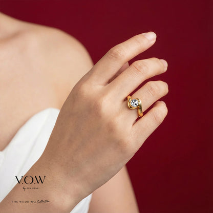 Flowing Romance Ring in 22K yellow and white gold with a graceful wave design and shimmering gemstone accent.
