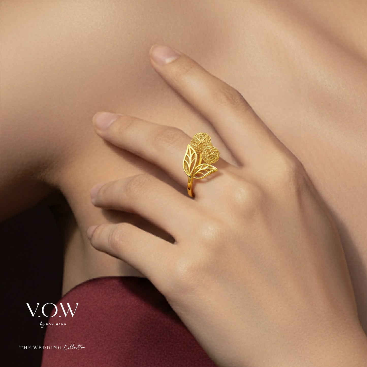 blissful eternity ring in 22k yellow gold featuring floral design and leaf accents on a hand.