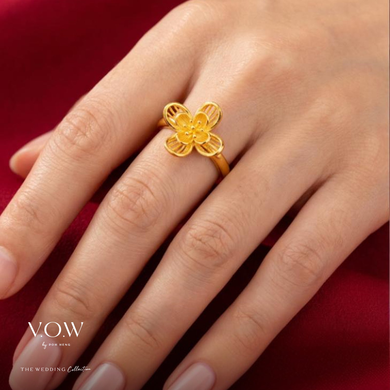 Flower ring in 24K yellow gold featuring a floral design, showcasing intricate detailing and a polished finish.