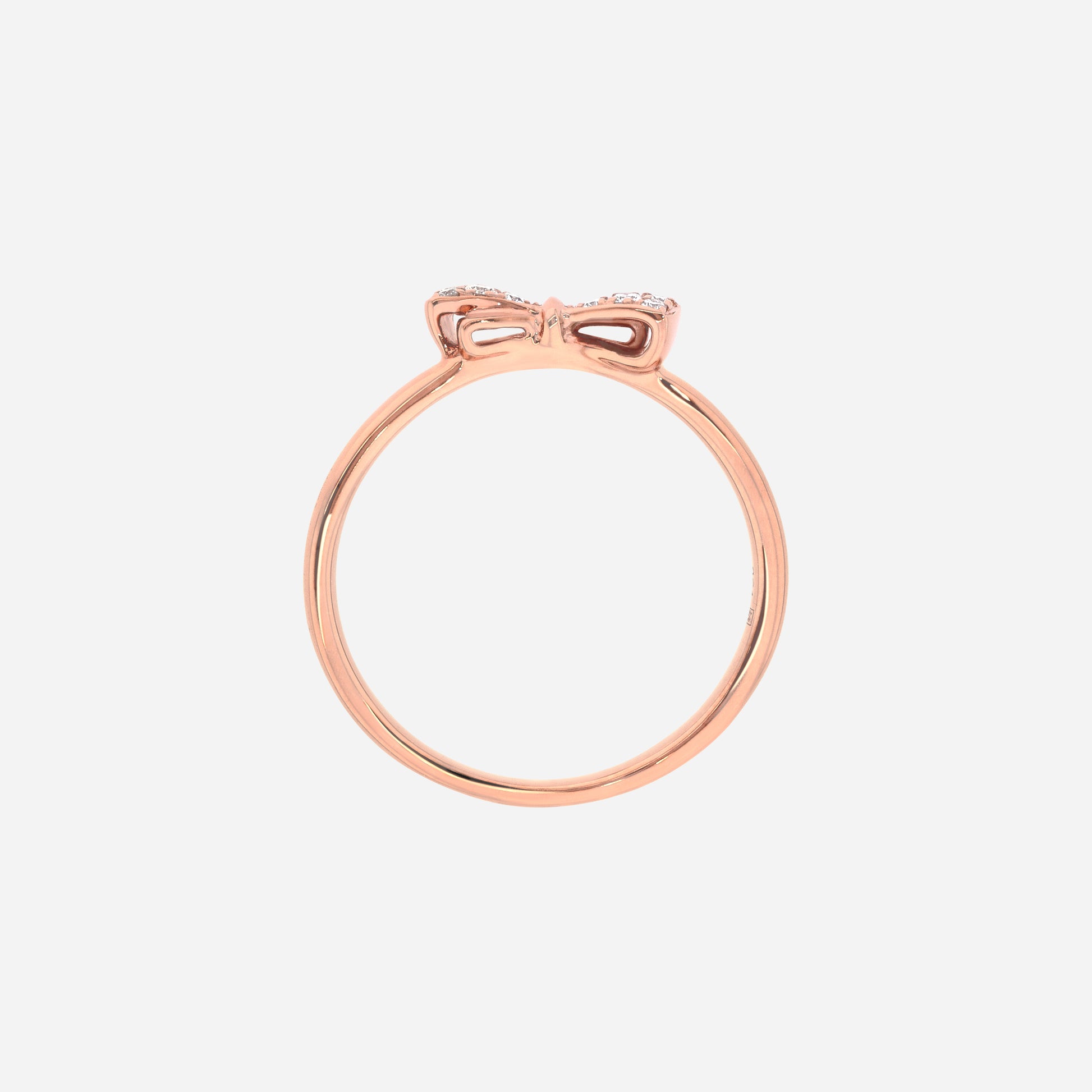 Dulcea Bow Diamond Ring in 18K rose gold with a petite diamond-set bow on a slender band.