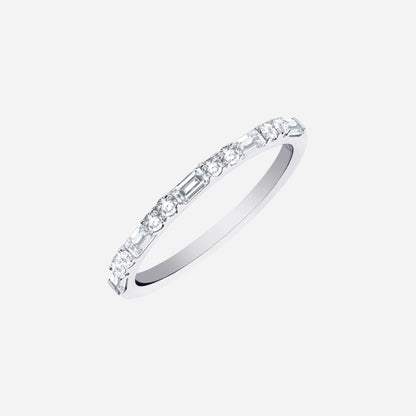 Slim polished white gold diamond ring with alternating round and baguette-cut diamonds, modern sparkle design.