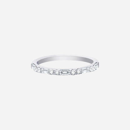 Slim polished white gold ring set with alternating diamond cuts for a modern sparkle. Ideal for stacking or solo wear.