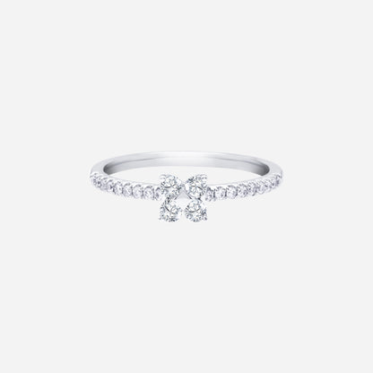 Glimmer Blossom diamond ring in 18K white gold with floral diamond cluster and pavé-lined band. Elegant and feminine design.