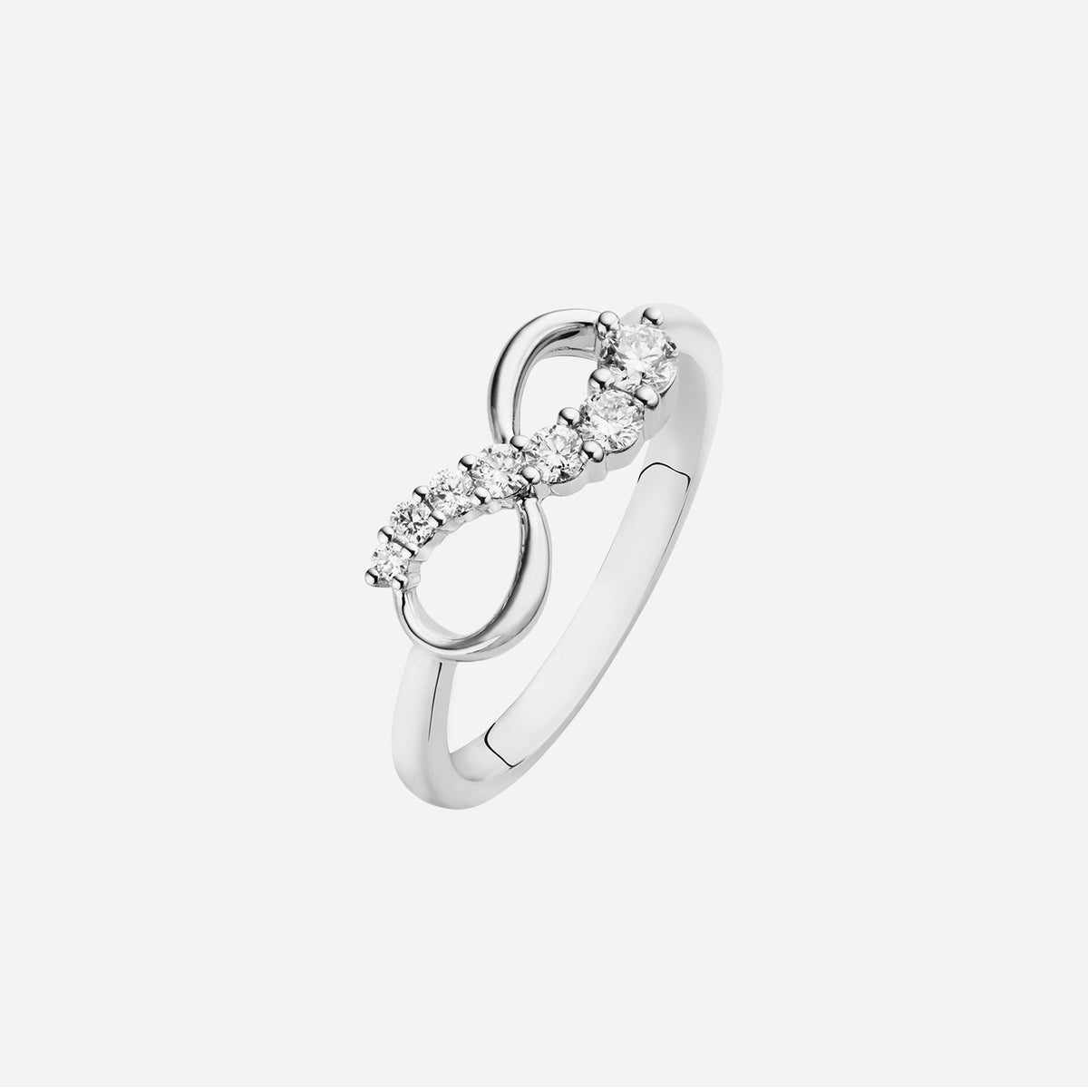 brilliant cut diamond infinity ring design in 18k white gold, featuring ascending sizes of diamonds.