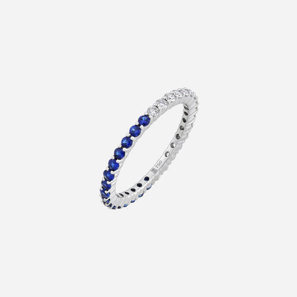 Blue sapphire and diamond ring in 18K white gold, featuring alternating deep blue sapphires and brilliant diamonds.