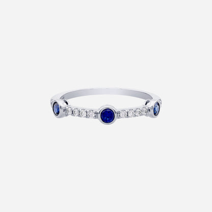 Blue sapphire and diamond ring in 18K white gold with round sapphires and fine diamond detailing.