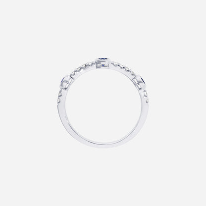 Blue sapphire and diamond ring in 18K white gold with round sapphires and diamond accents on a slender band.