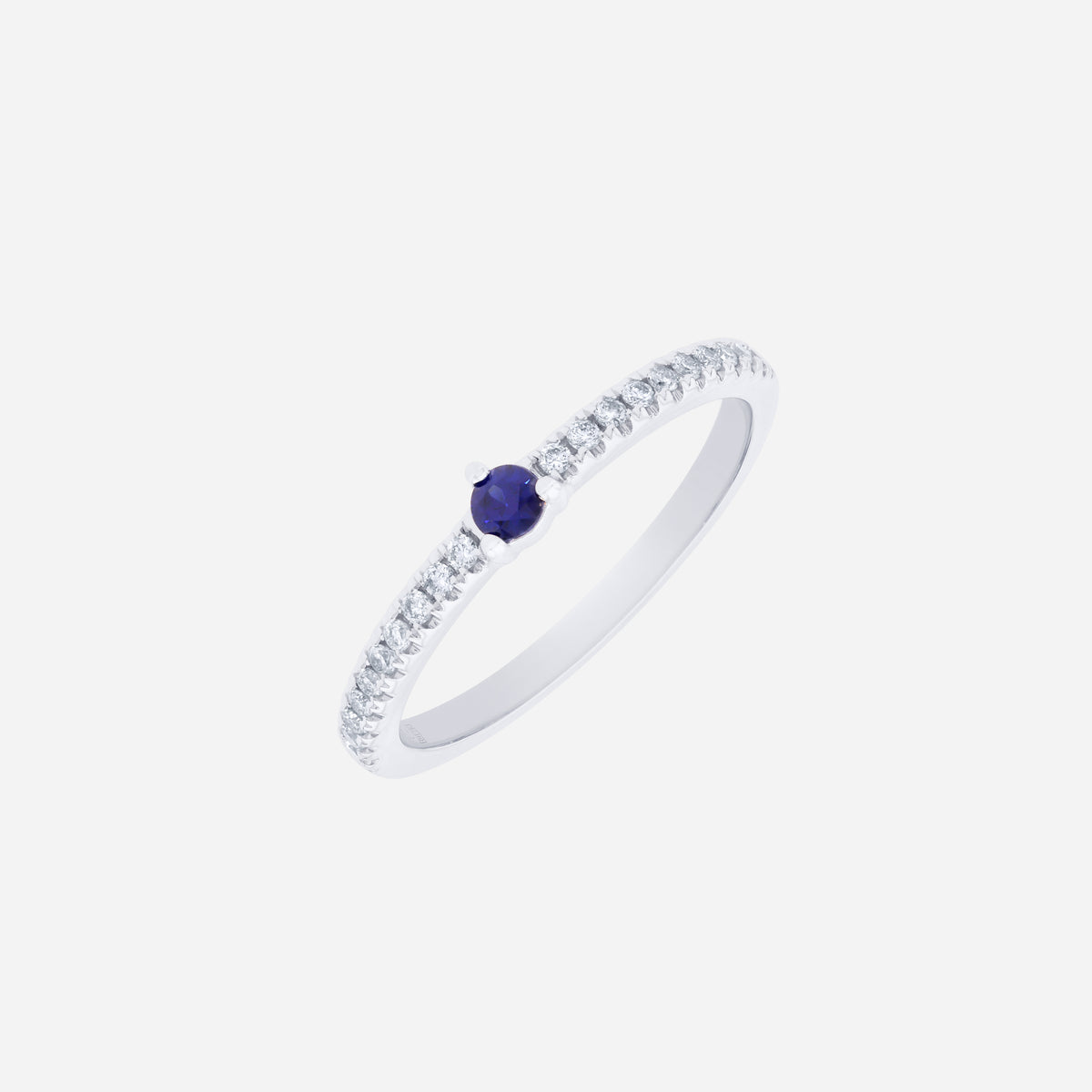 Blue sapphire and diamond ring in 18K white gold with a round blue sapphire center and sparkling diamond accents.