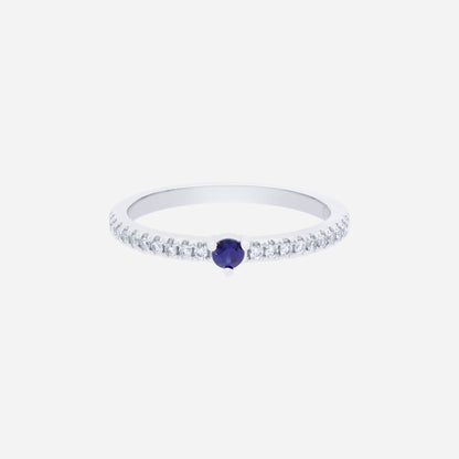Blue sapphire and diamond ring in 18K white gold with a round sapphire center and sparkling diamond accents.