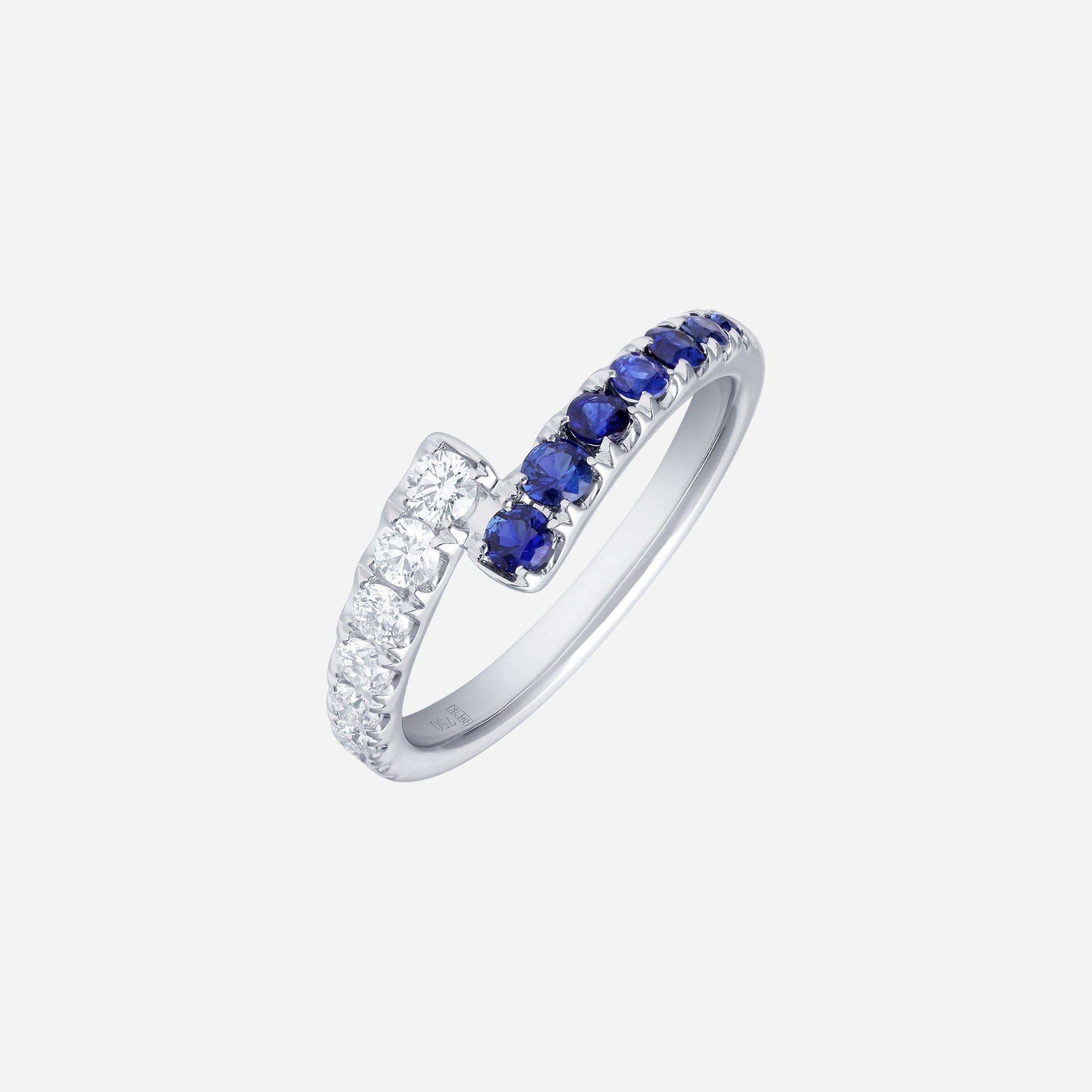 Blue sapphire and diamond ring in 18K white gold, featuring a curve of deep-blue sapphires and sparkling diamonds.