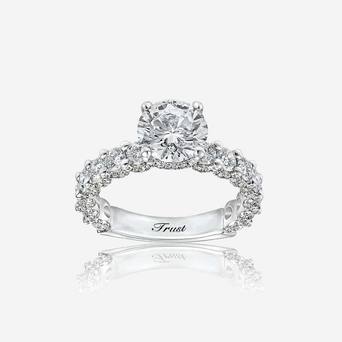 trust invisible diamond ring in white gold with a round center stone and sparkling halo design.