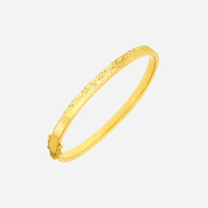 Radiant bangle in 22K yellow gold with a textured design, perfect for elegant wrist adornment.