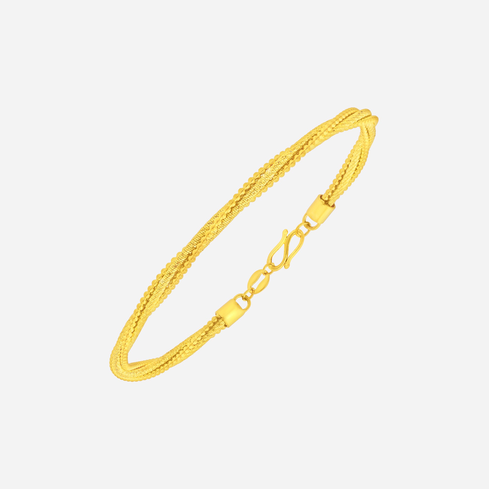 Twisted bangle in 24K yellow gold featuring rope-like detailing and refined texture for timeless elegance.