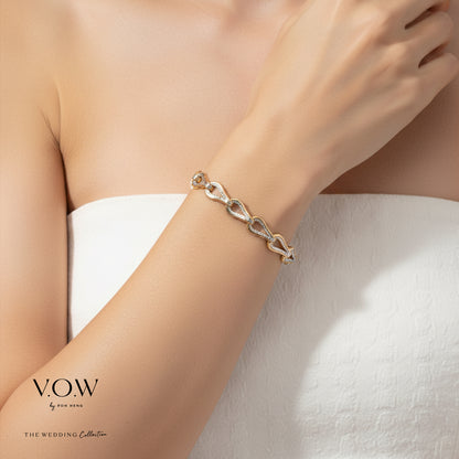 Elegance Omega Bracelet in yellow and white gold, featuring a linked heart design for bridal elegance.